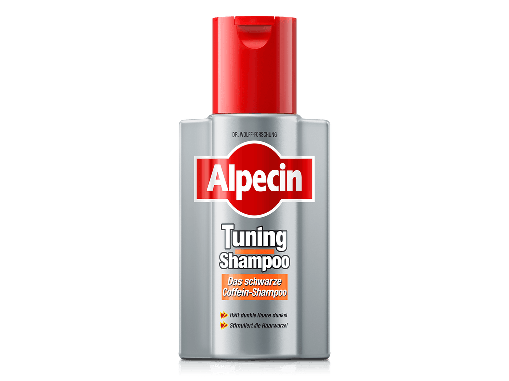 Vorderseite der Alpecin Tuning Shampoo Flasche mit rotem Verschluss. Silbergraues Design mit rotem Alpecin-Logo, darunter Tuning Shampoo und Das schwarze Coffein-Shampoo. Orangefarbene Pfeile mit Hinweisen Hält dunkle Haare dunkel und Stimuliert die Haarwurzel.